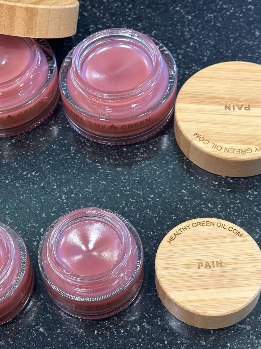 Close view of Healthy Green balm texture in the open glass jar