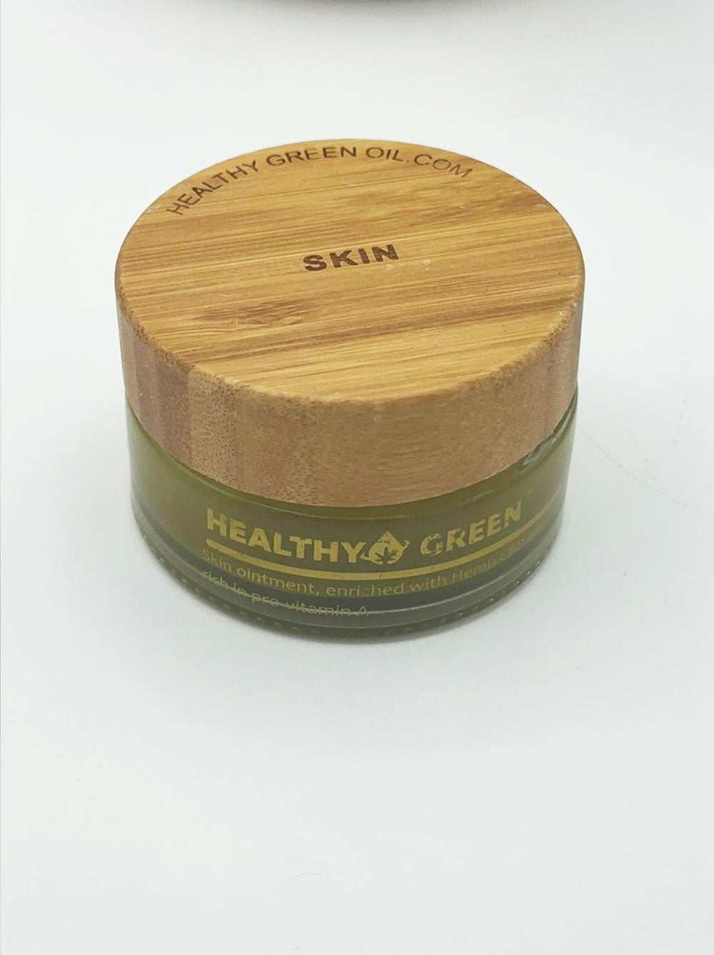Healthy Green Botanical Balm — Skin, jar open beside its bamboo lid